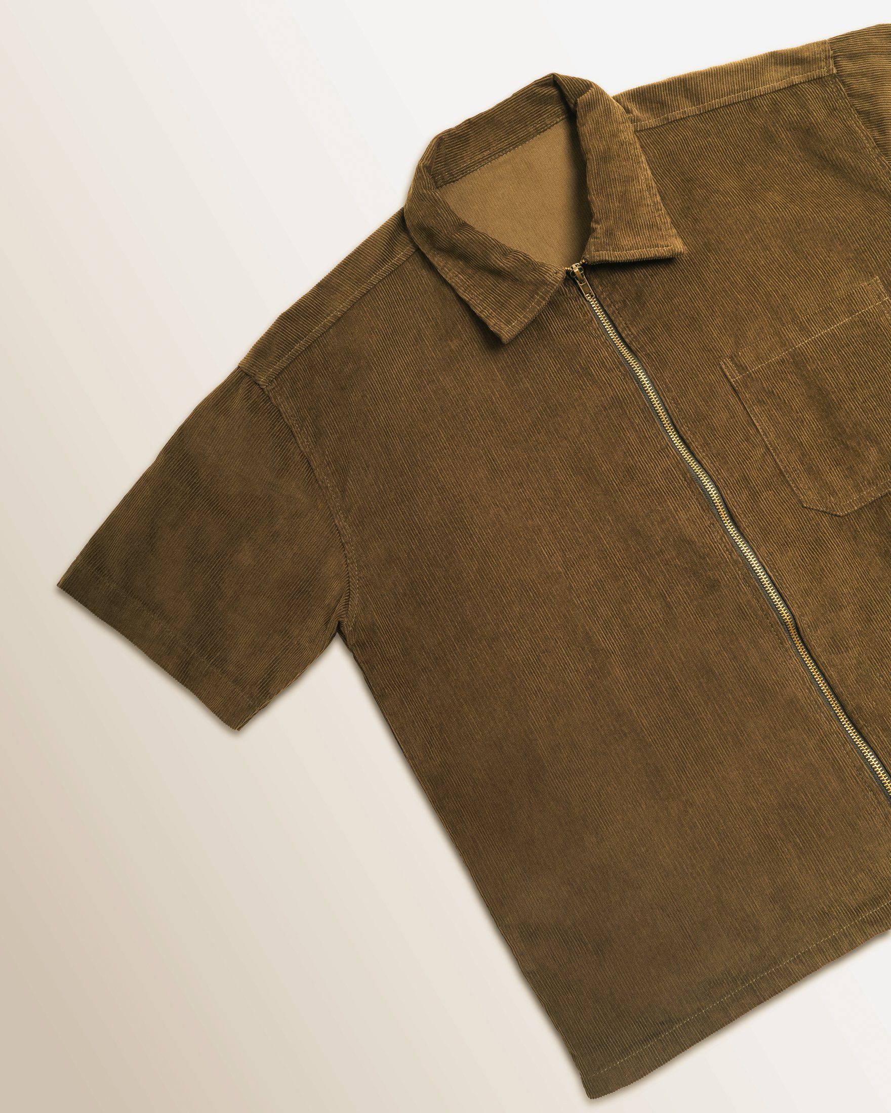 Olive workshirt laid at an angle