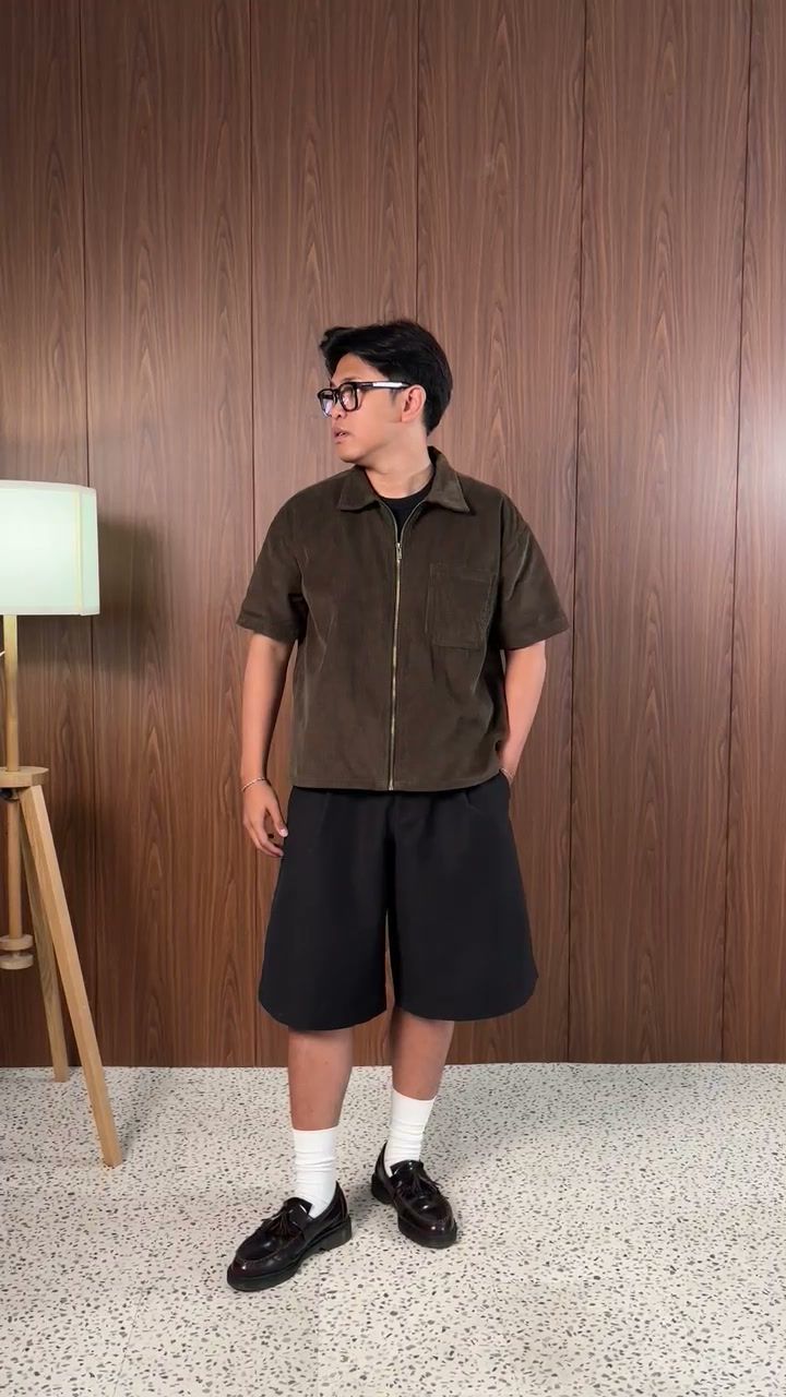Man in the army green workshirt turning to show the back